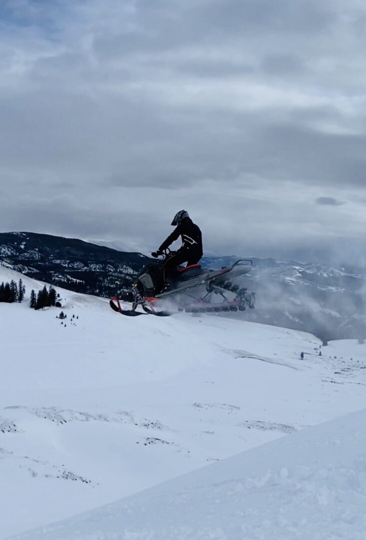 A man riding a Brenden sled in an ice mountain