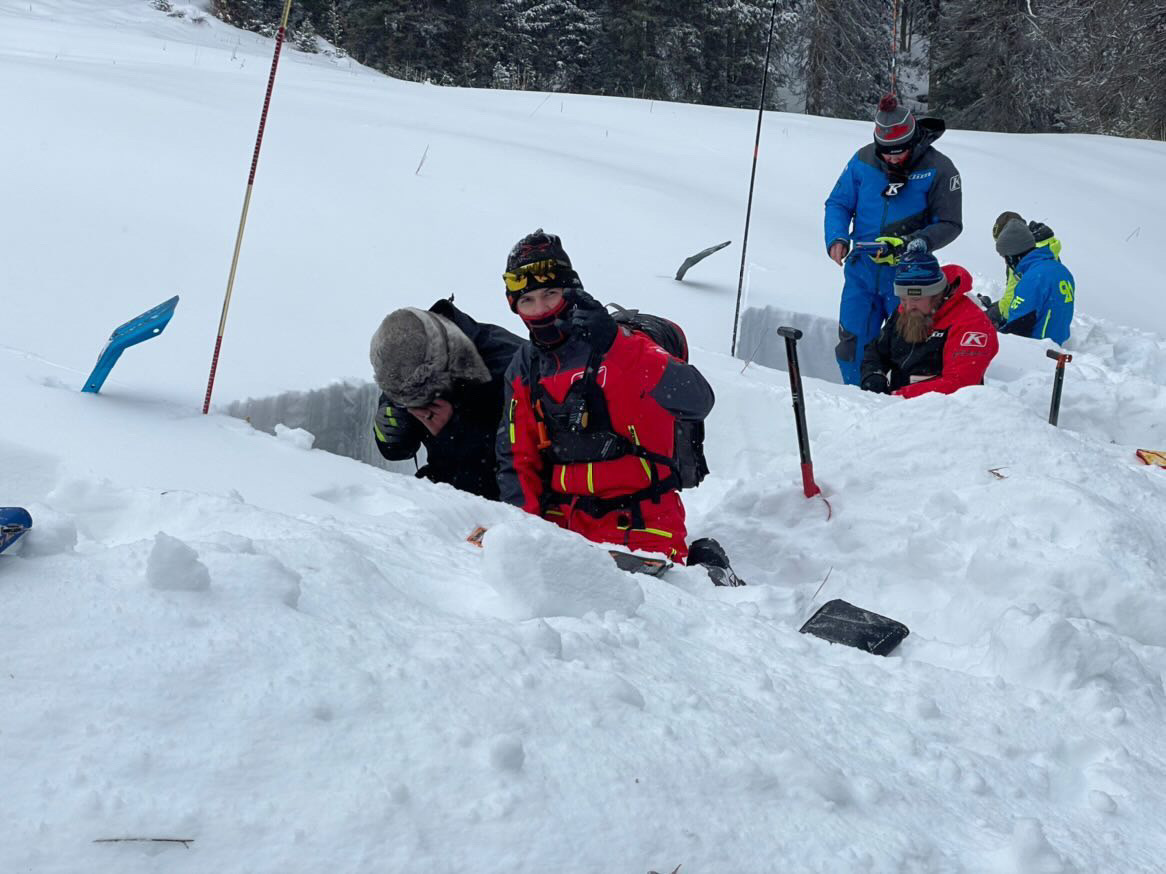 Some people digging holes inside a mountain full of ice
