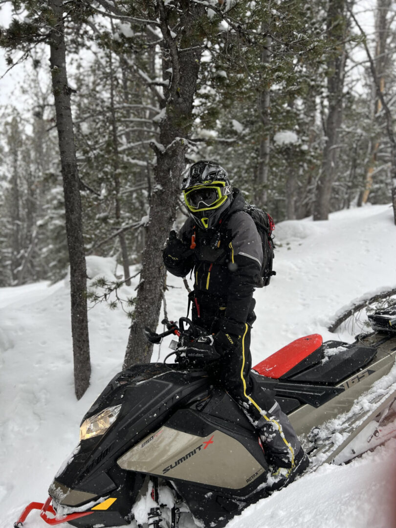 A man standing while riding on a Brenden sled